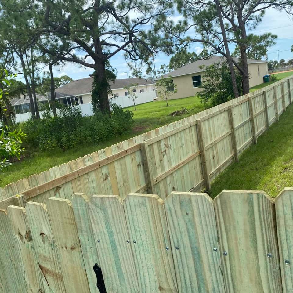Weathered wood privacy fence panels along a residential side yard — Lobo Fences LLC, Southwest Florida