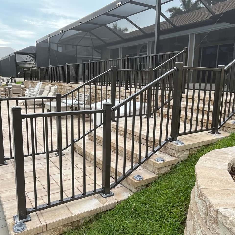 Black aluminum railing with steps and a gate at a screened pool enclosure — Lobo Fences LLC, Southwest Florida