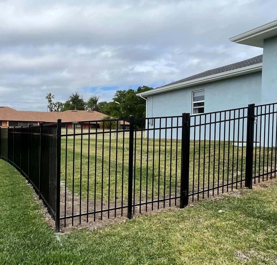 Black aluminum flat-top fence enclosing a residential backyard — Lobo Fences LLC, Southwest Florida